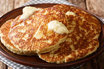 Delicious grilled pancakes with butter close-up on a plate. horizontal