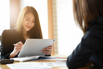 Business woman using tablet for financial in meeting room