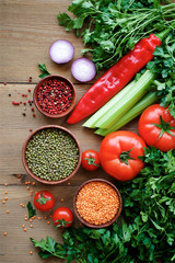 Variety of vegetables and legumes on wooden table. Vegan food concept