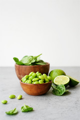 Edamame beans in bowl on light background. Close up view