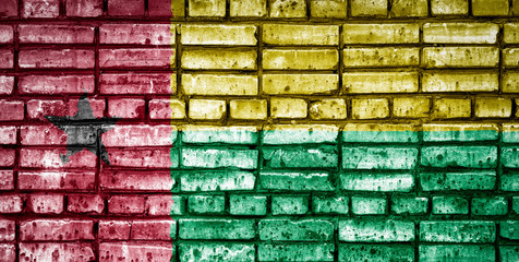 National flag of Guinea bissau on a brick background. Concept image for Guinea bissau: language , people and culture.