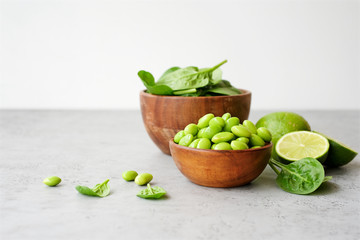 Edamame beans in bowl on light background. Close up view