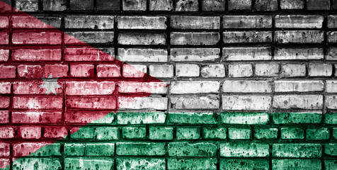 National flag of Jordan on a brick background. Concept image for Jordan: language , people and...
