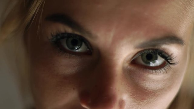 Close up face woman looking to camera. Portrait sad woman. Female face, eyes, eyelashes and eyesbrows. Natural beauty and makeup.