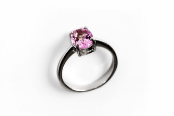 Luxury ring with pink sapphire isolated on white background