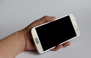 A hand holding a Smartphone.