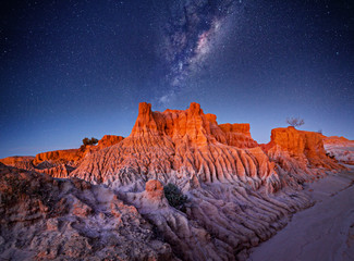 Starry skies over desert landscape - 250177004