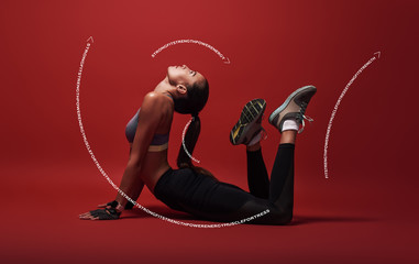 Keeping my muscles flexible. Sportswoman lying over red background, stretching her body. Graphic drawing.
