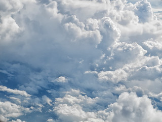 Fototapeta na wymiar White clouds high above the ground