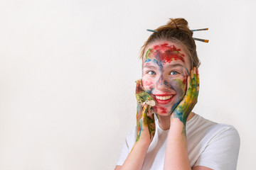 Portrait of a girl artist with make-up make-up of paint in the hands of a palette of colors and a...