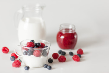 Yogurt with blueberry and raspberry berries in a glass Cup on a white background. Breakfast. Healthy diet.