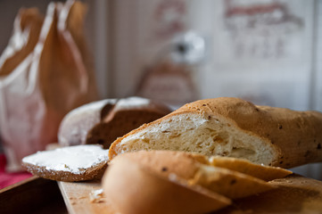 Sliced baguette and round rye black bread. Sandwich with bread, butter and dill. White loaf and rye bread close up and copy space
