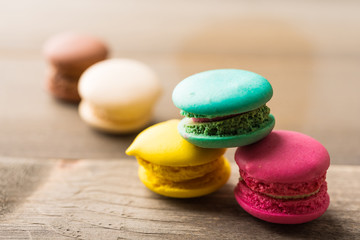 Colorful Macaron in natural light on wood background