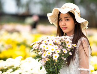 Beautiful girl with flowers in the garden.