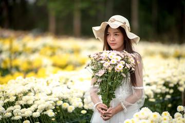 Beautiful girl with flowers in the garden.