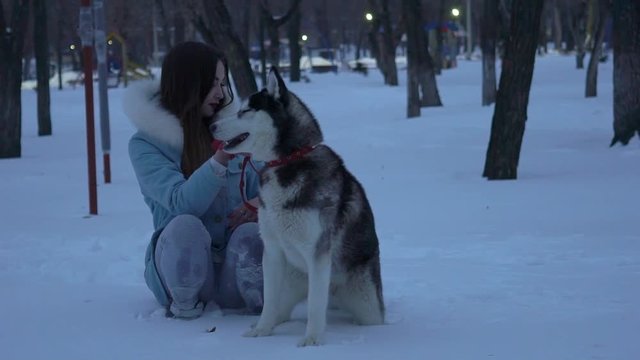 Woman Walk In The Winter Forest With A Dog