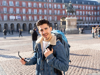 Handsome young caucasian tourist man happy and excited traveling around europe