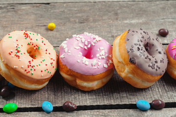 Glazed donuts on wooden background
