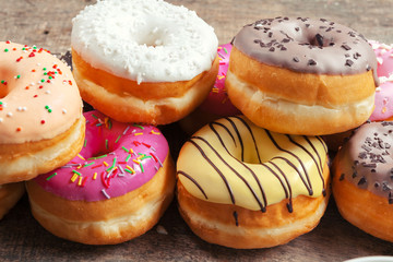 Glazed donuts on wooden background