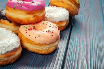 Glazed donuts on wooden background