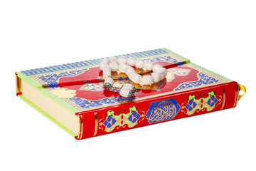 Islamic Book Holy Quran and beads on withe background