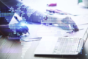 Double exposure of World map polygonal with person writing in notepad. Globalization concept.