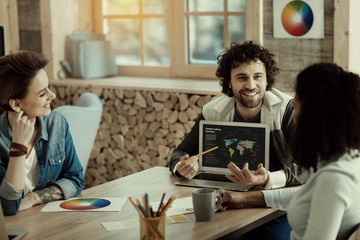 Colleagues in the office discussing their achievements