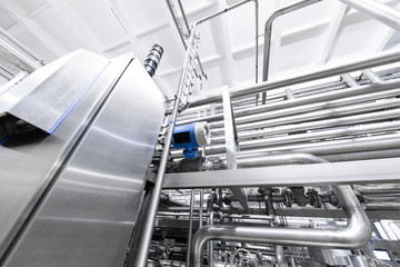 Chrome pipes and blue element. Industrial background