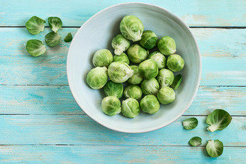  Fresh Brussels Sprouts on azure wooden background. Clean and healthy food concept. Spring  ingredients
