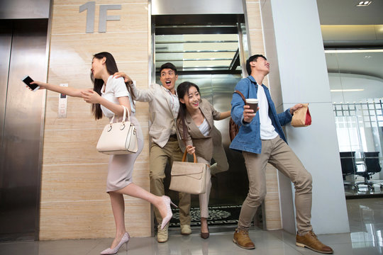 Business men and women crowded elevators
