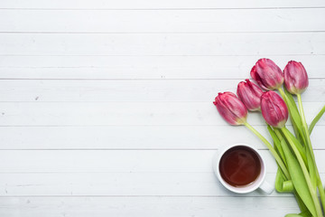 Overhead view of a bouquet of tulips and a Cup of coffee. copy space. Flat lay, top view
