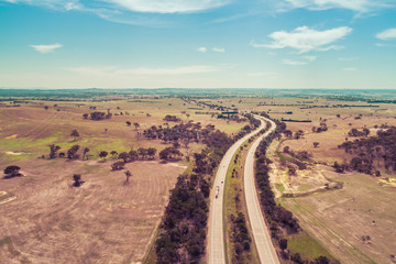 Aerial landscape of Hume Highway passing through agricultural land. Cullerin, New South Wales,...