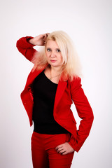 Beautiful European girl with blond hair in a red jacket