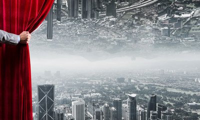 Modern business reflected cityscape behind curtain opened by businessman hand