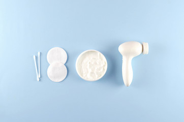 Care cosmetics and beauty accessories on a blue background.