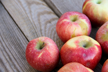 Fresh red apples on wooden table