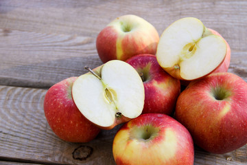 Fresh red apples on wooden table