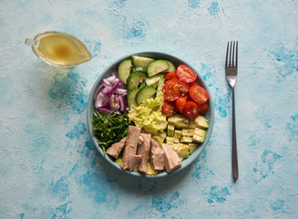 Healthy salad of avocado, tomatoes and canned tuna