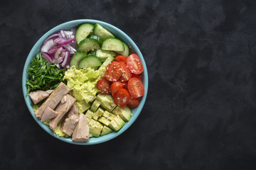 Healthy salad of avocado, tomatoes and canned tuna