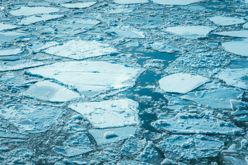 Aerial view of frozen lake. Cracked Ice from drone view. Background texture concept