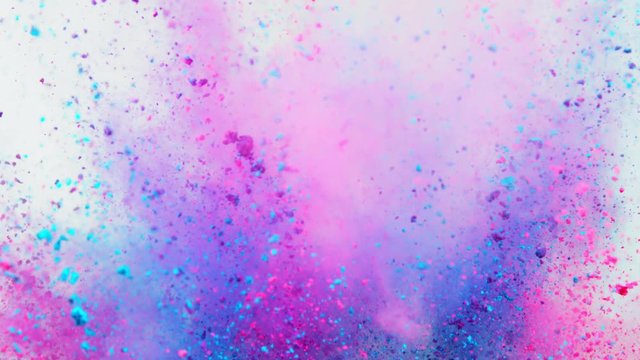 Super slowmotion shot of color powder explosion isolated on white background.