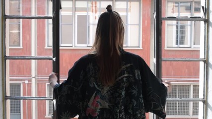 slow motion young woman indoors opening window stretching arms – morning, waking up, positive emotions concept