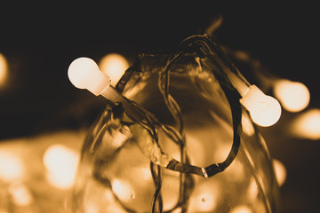 Fototapeta na wymiar Yellow Christmas lighting garland in the darkness.