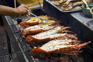 Grilled lobsters on street food market in Thailand