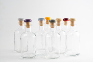small glass bottles with colored cap