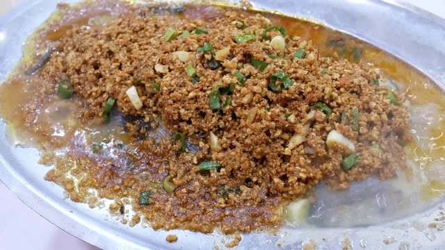 Motion of steamed codfish with savory crisbean and heavy steam inside Chinese restaurant with 4k resolution.