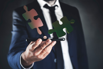 man hand phone with puzzle