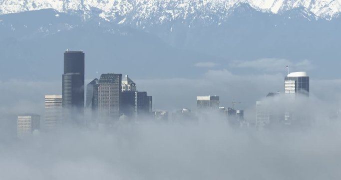 4K time-lapse of Seattle above a river of clouds and surrounded by dense morning mist in winter