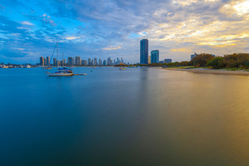 Moored sailboats and skyscrapers at sunset - long exposure. Gold Coast, Queensland, Australia