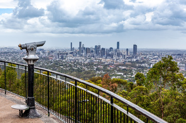 Coin-operated binoculars pointed at Brisbane CBD skyline from lookout - obrazy, fototapety, plakaty